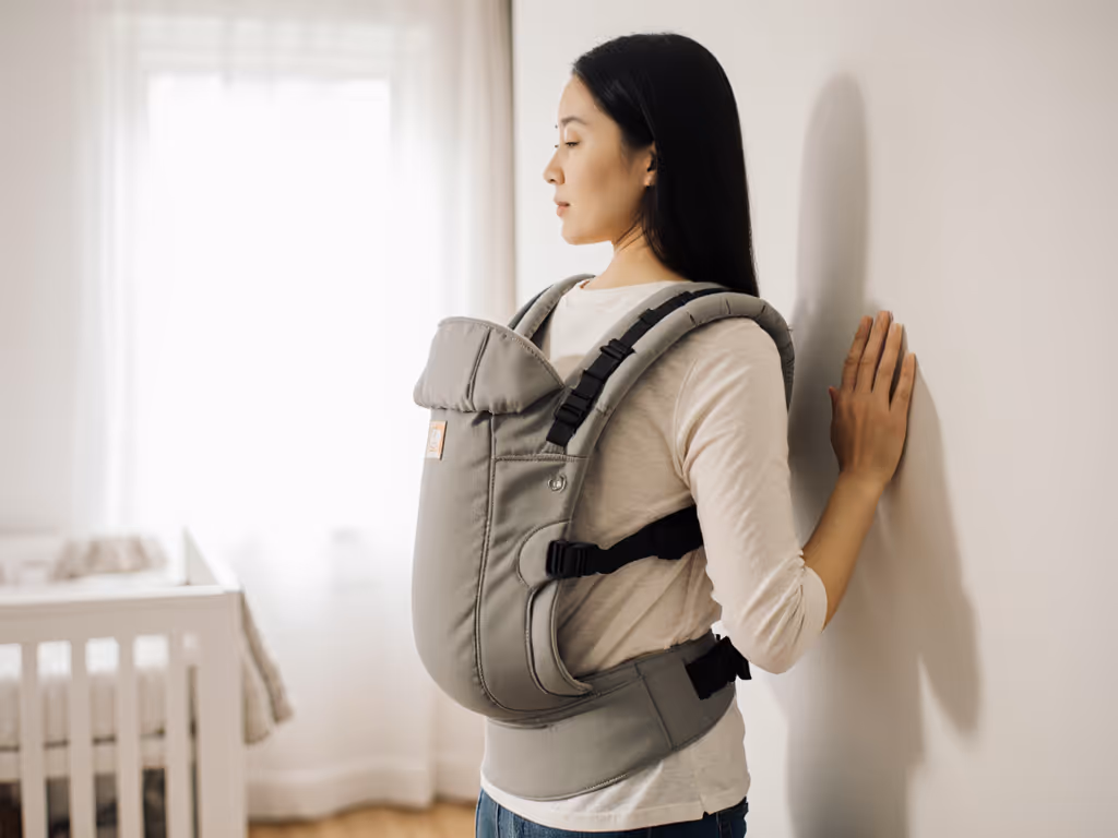 caregiver_conducting_wall_test_with_baby_carrier